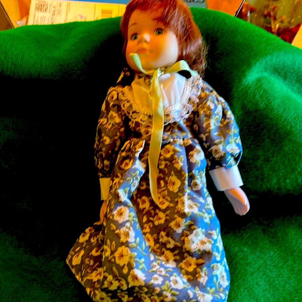 Vintage doll with porcelain face, hands. Has blue eyes that do not move . 13 in
